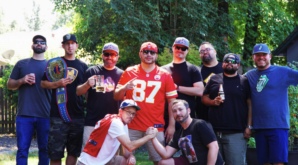 The Sunday Hu$tle league members posing with the championship belt